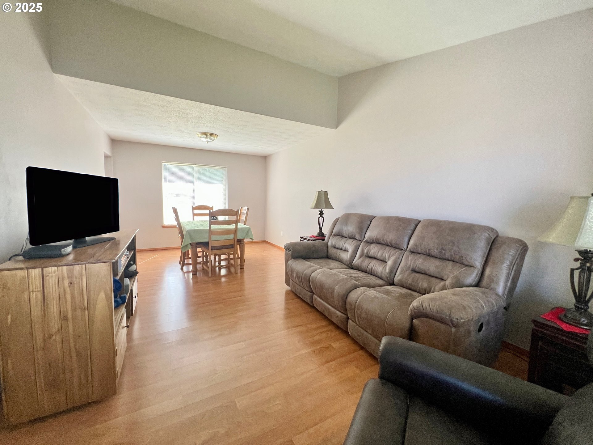 112 Northeast 11th Street Hermiston, OR 97838 - Photo 6 of 23 a living room with furniture and a flat screen tv