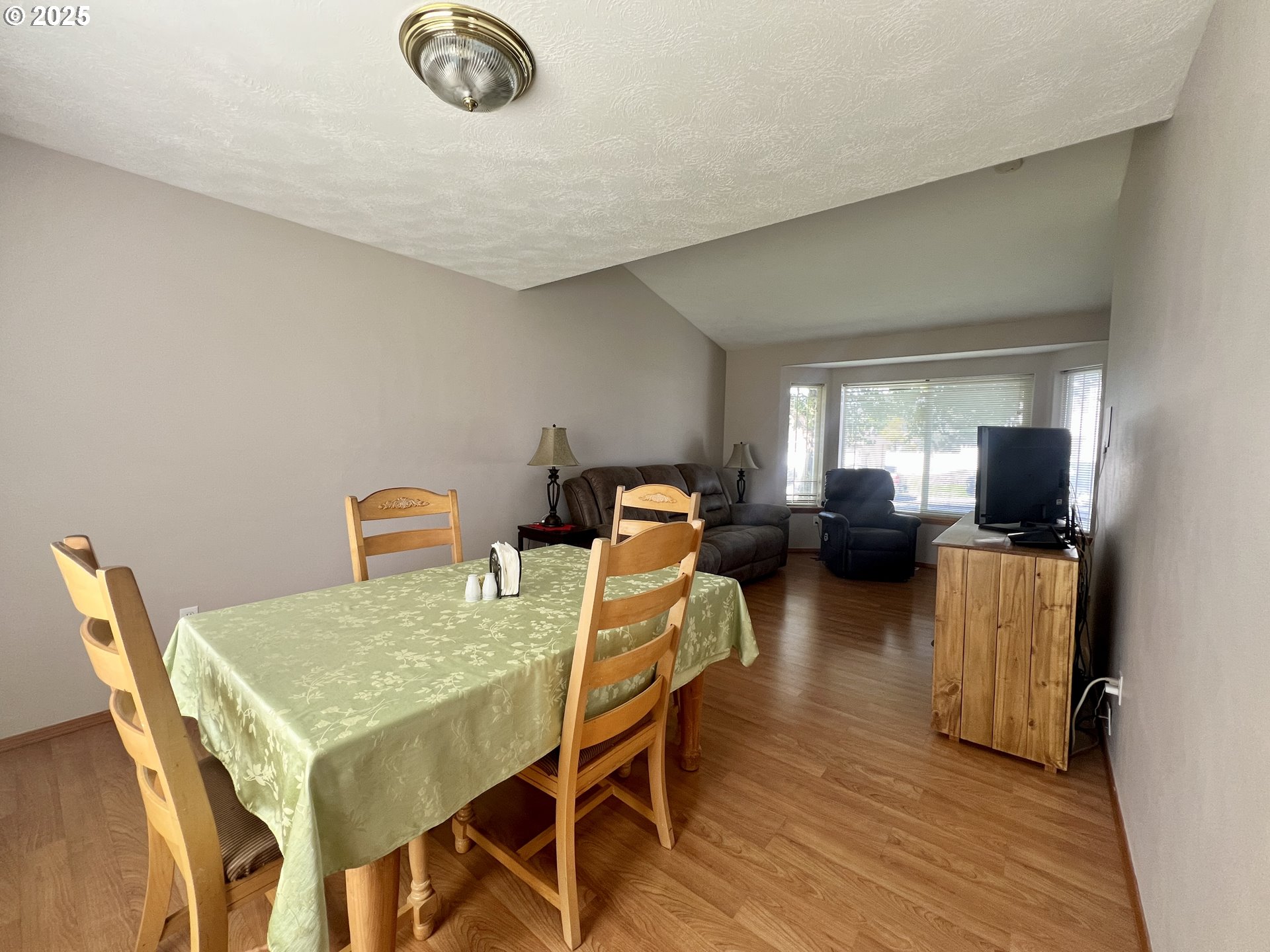 112 Northeast 11th Street Hermiston, OR 97838 - Photo 8 of 23 a view of a dining room with furniture and wooden floor