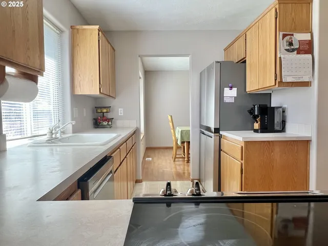 a view of a kitchen with kitchen island a sink and a large window
