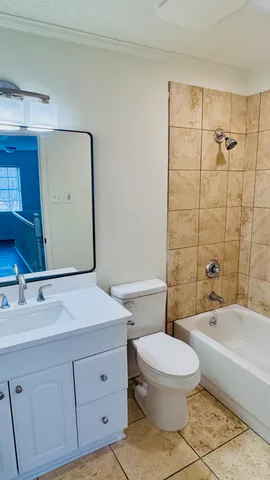 a bathroom with a toilet a sink a mirror and shower