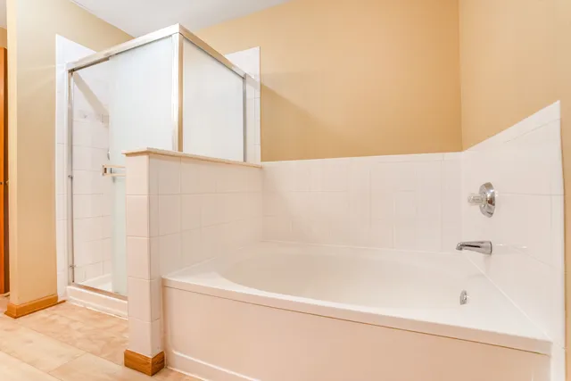 a bathroom with a bathtub and a shower