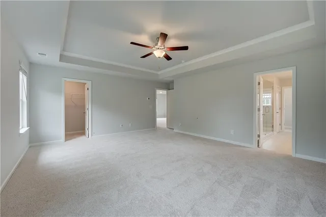 a view of an empty room with a ceiling fan