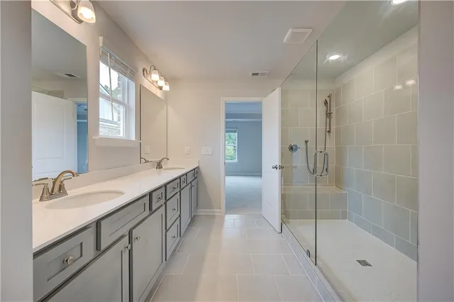a bathroom with a granite countertop sink a shower and a mirror