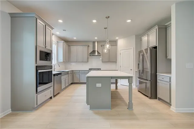 a kitchen with stainless steel appliances a refrigerator sink and microwave