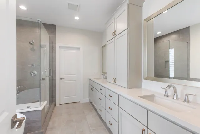 a bathroom with a granite countertop sink mirror and bathtub