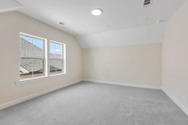a view of a house with a small yard and floor to ceiling window