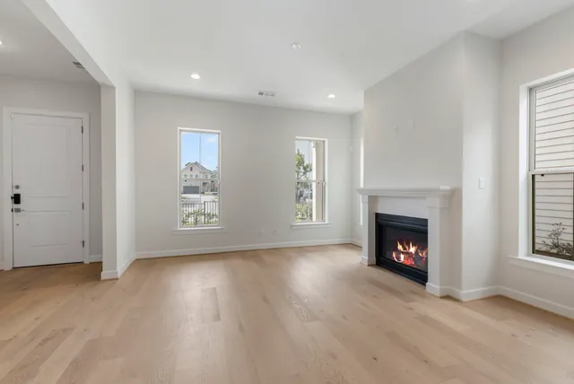 a view of a room with wooden floor and window