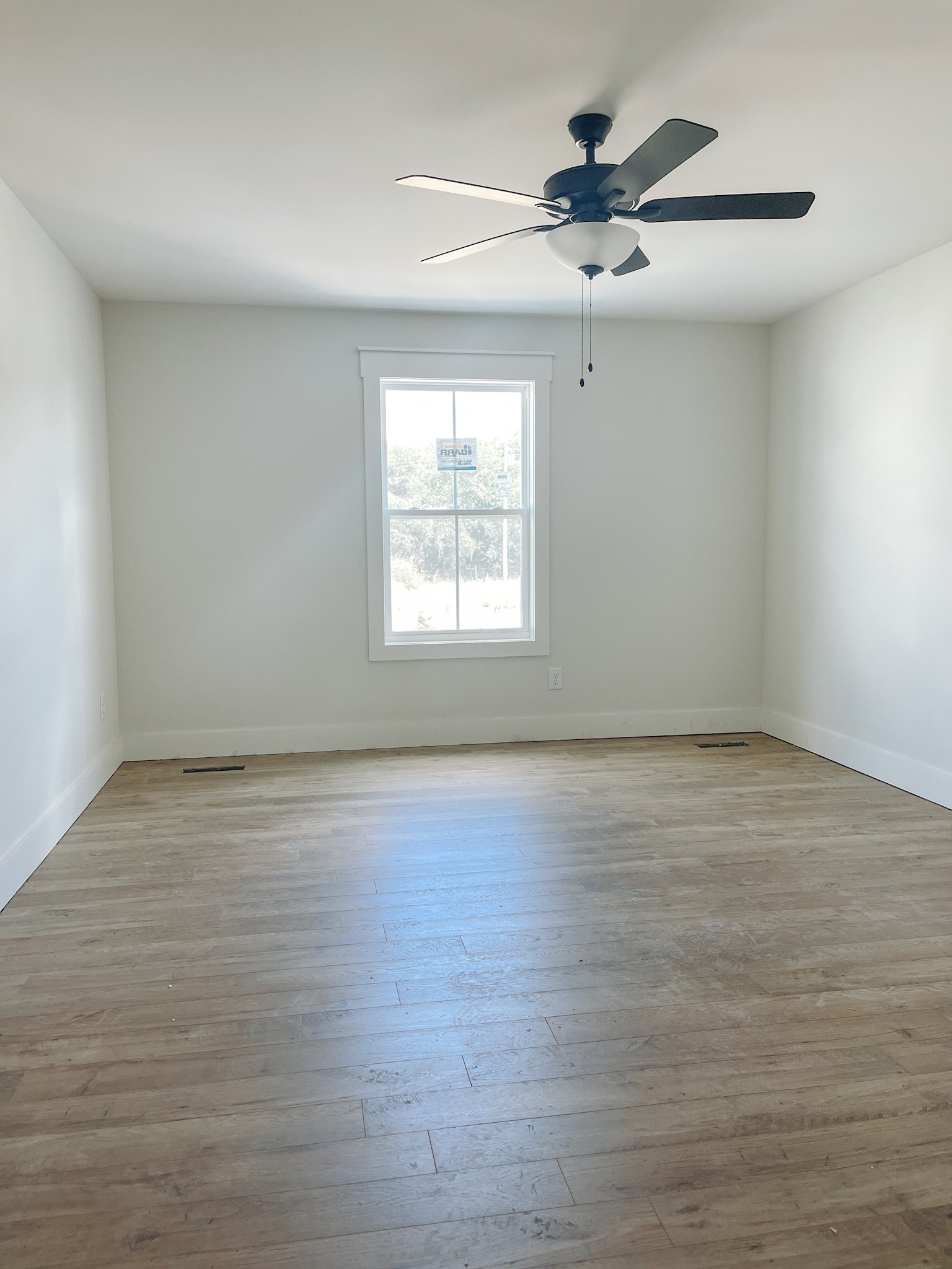 247 Tom Ferrell Road Portland, TN 37148 - Photo 7 of 10 wooden floor in an empty room with a window