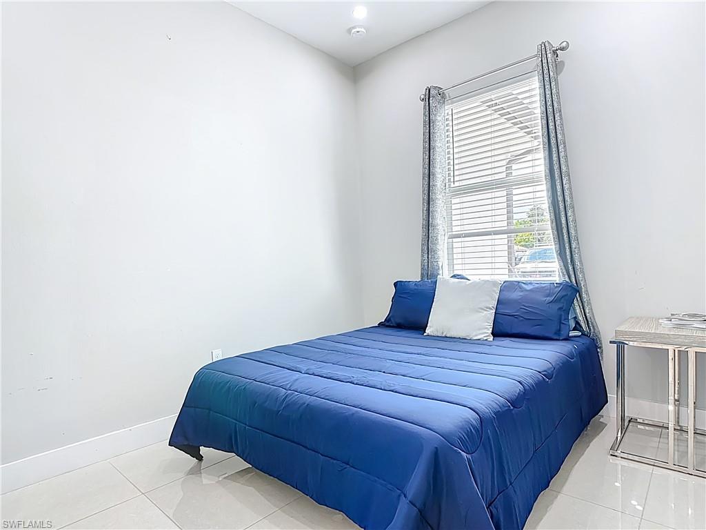 1806 41st Street Southwest Naples, FL 34116 - Photo 11 of 38 a bedroom with a bed and a window