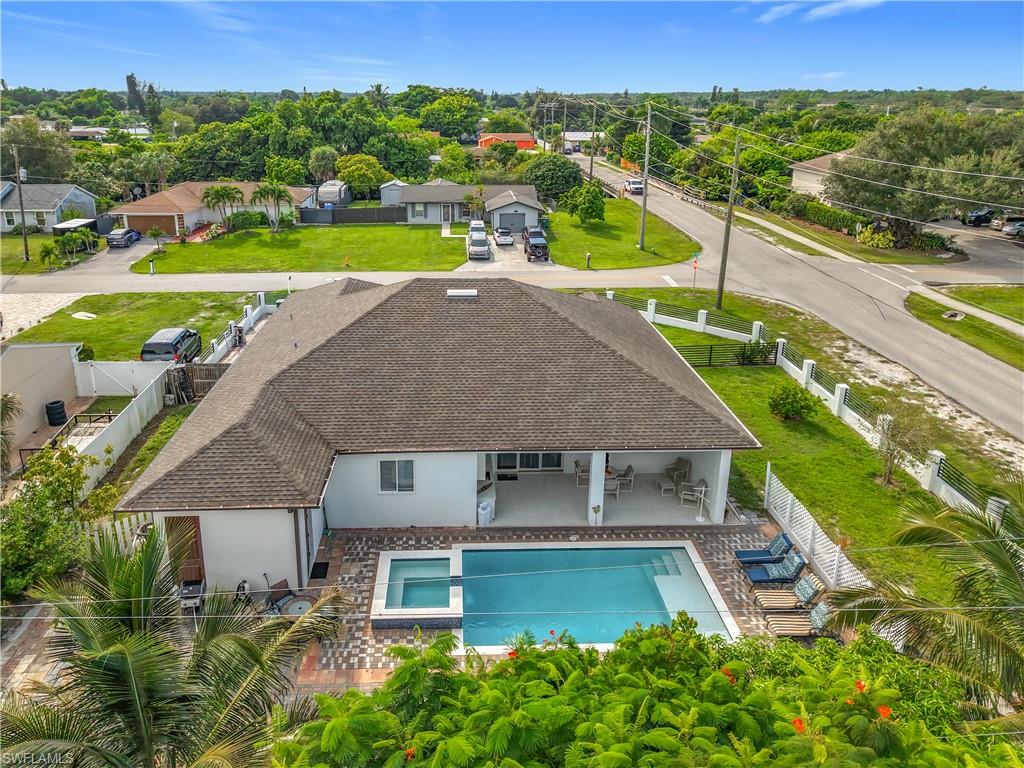 1806 41st Street Southwest Naples, FL 34116 - Photo 31 of 38 an aerial view of a house with a swimming pool outdoor seating and yard