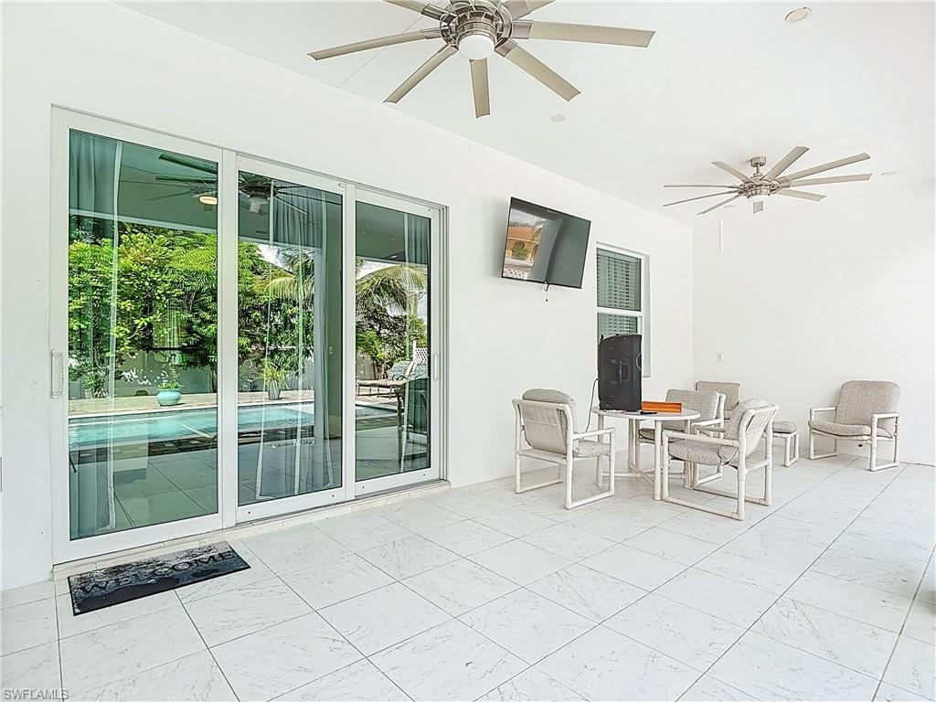 1806 41st Street Southwest Naples, FL 34116 - Photo 35 of 38 a living room with furniture and a window