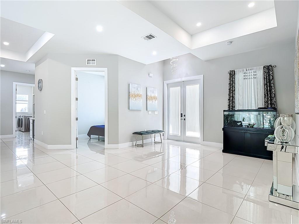 1806 41st Street Southwest Naples, FL 34116 - Photo 4 of 38 a kitchen with granite countertop a refrigerator and a sink