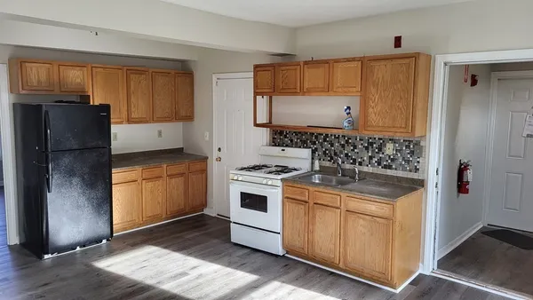 a kitchen with stainless steel appliances granite countertop a refrigerator and a stove
