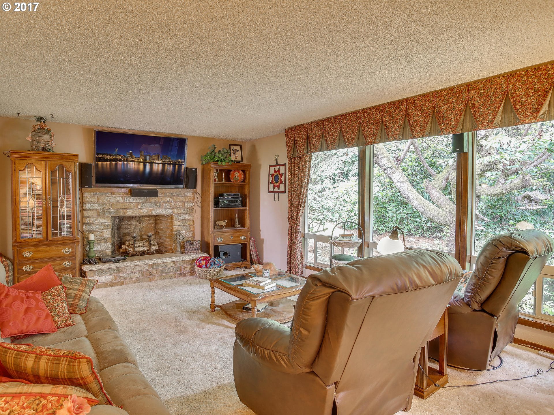 22374 Southeast Ridgeview Drive Damascus, OR 97089 - Photo 16 of 32 a living room with furniture a fireplace and a large window