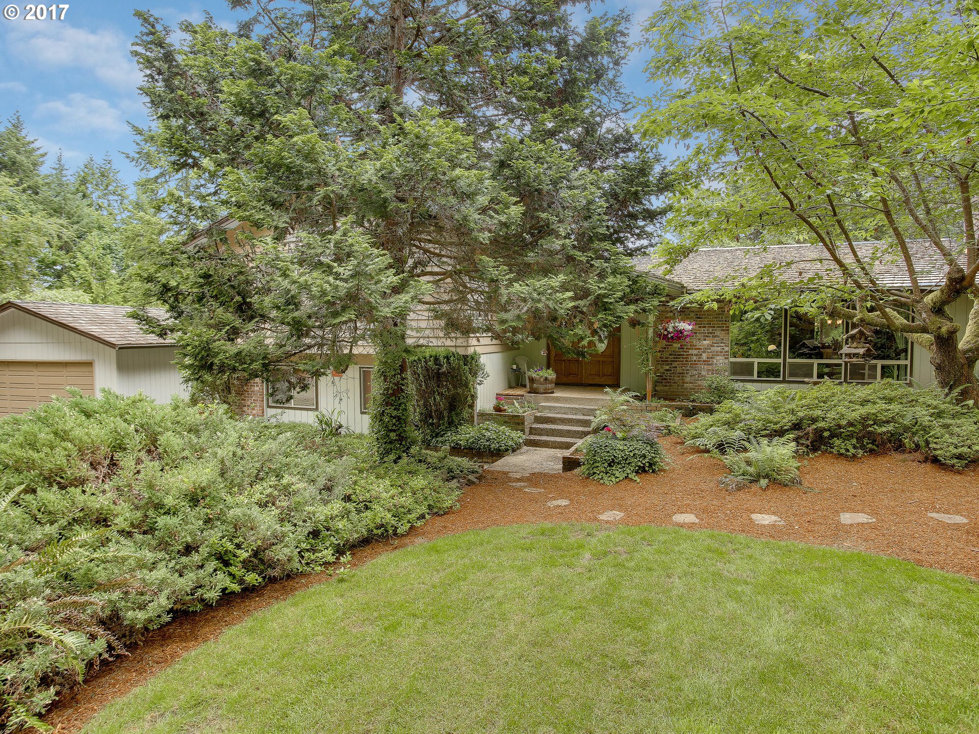 22374 Southeast Ridgeview Drive Damascus, OR 97089 - Photo 2 of 32 a pathway of a house with yard and green space