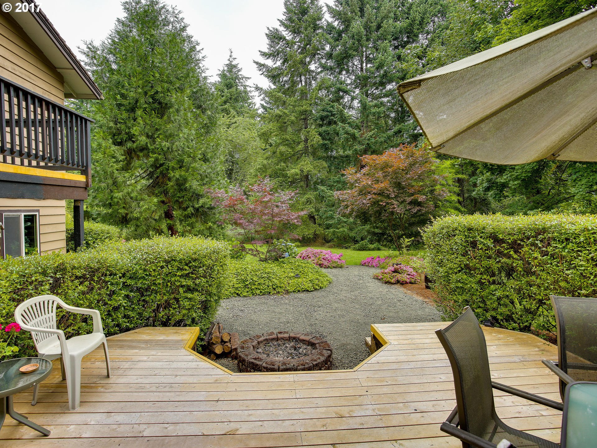 22374 Southeast Ridgeview Drive Damascus, OR 97089 - Photo 9 of 32 a view of a chair and tables back yard of the house