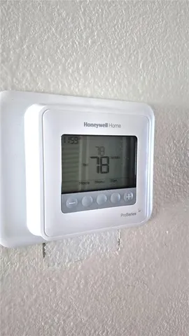 a view of a patio with a table and chairs under an umbrella
