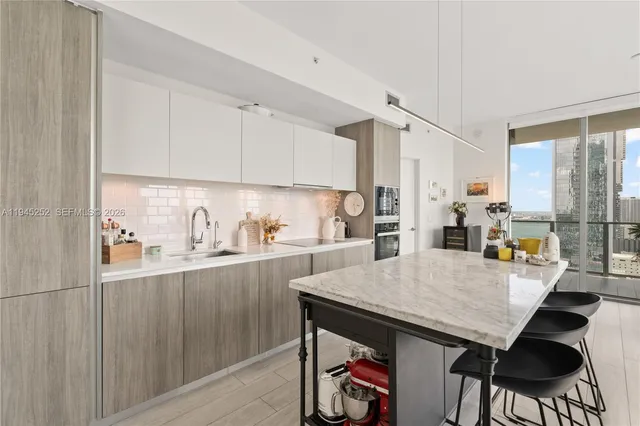 a kitchen with a sink appliances and cabinets