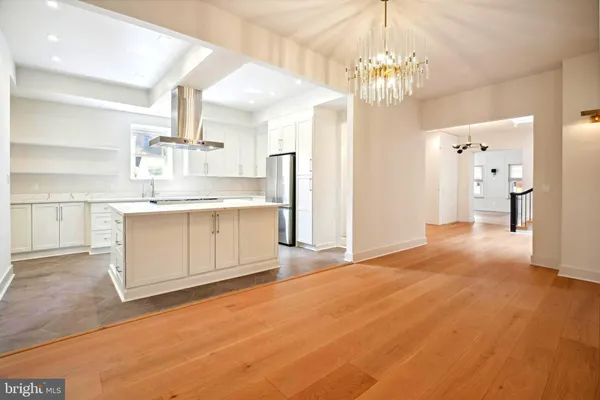 a view of a kitchen with a sink cabinets and wooden floor