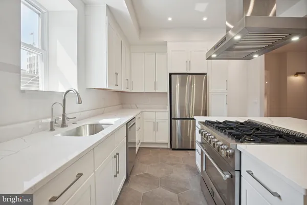 a kitchen with a stove and a chandelier