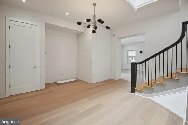 a view of kitchen with wooden floor and electronic appliances