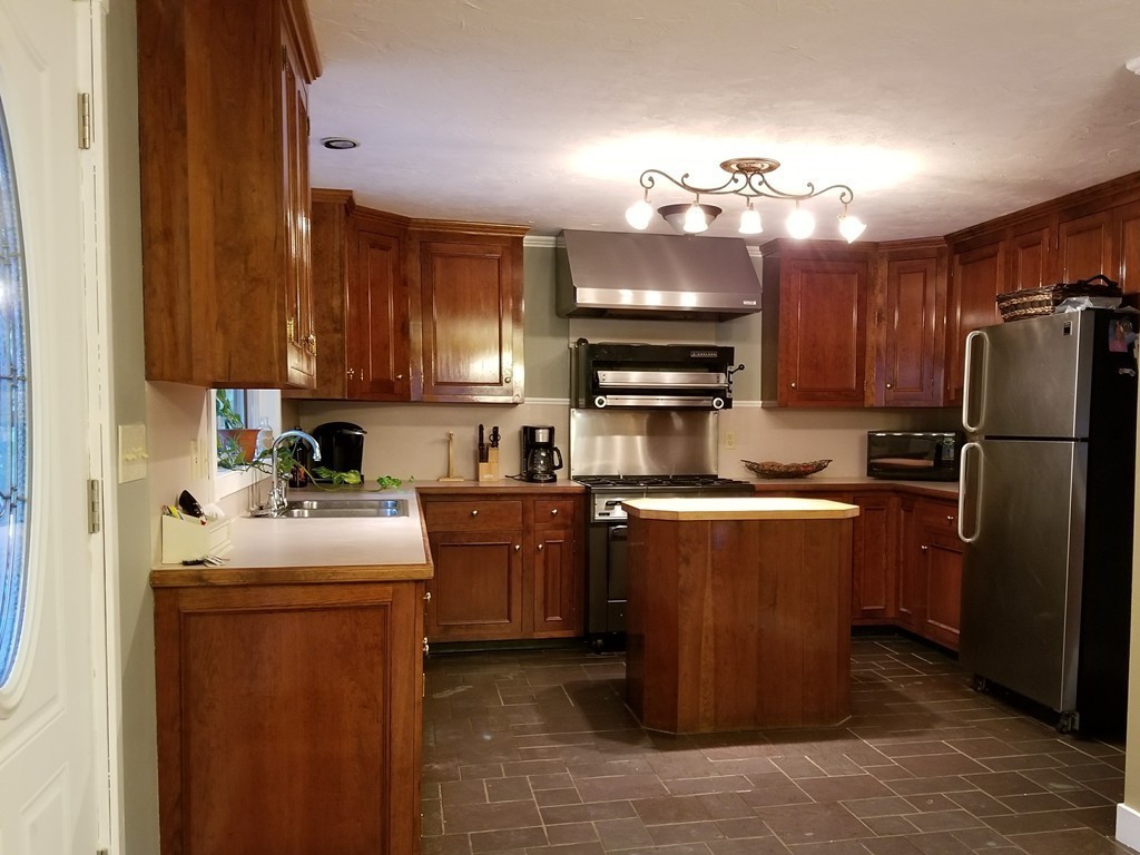 47 Laurel Lake Road Royalston, MA 01368 - Photo 2 of 10 a kitchen with stainless steel appliances granite countertop a refrigerator a sink dishwasher a stove top oven a sink and dishwasher