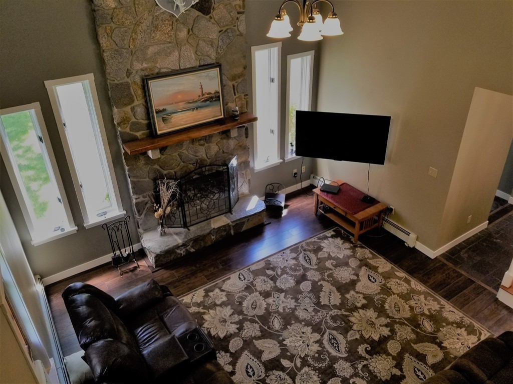 47 Laurel Lake Road Royalston, MA 01368 - Photo 7 of 10 a living room with a fireplace furniture and a flat screen tv