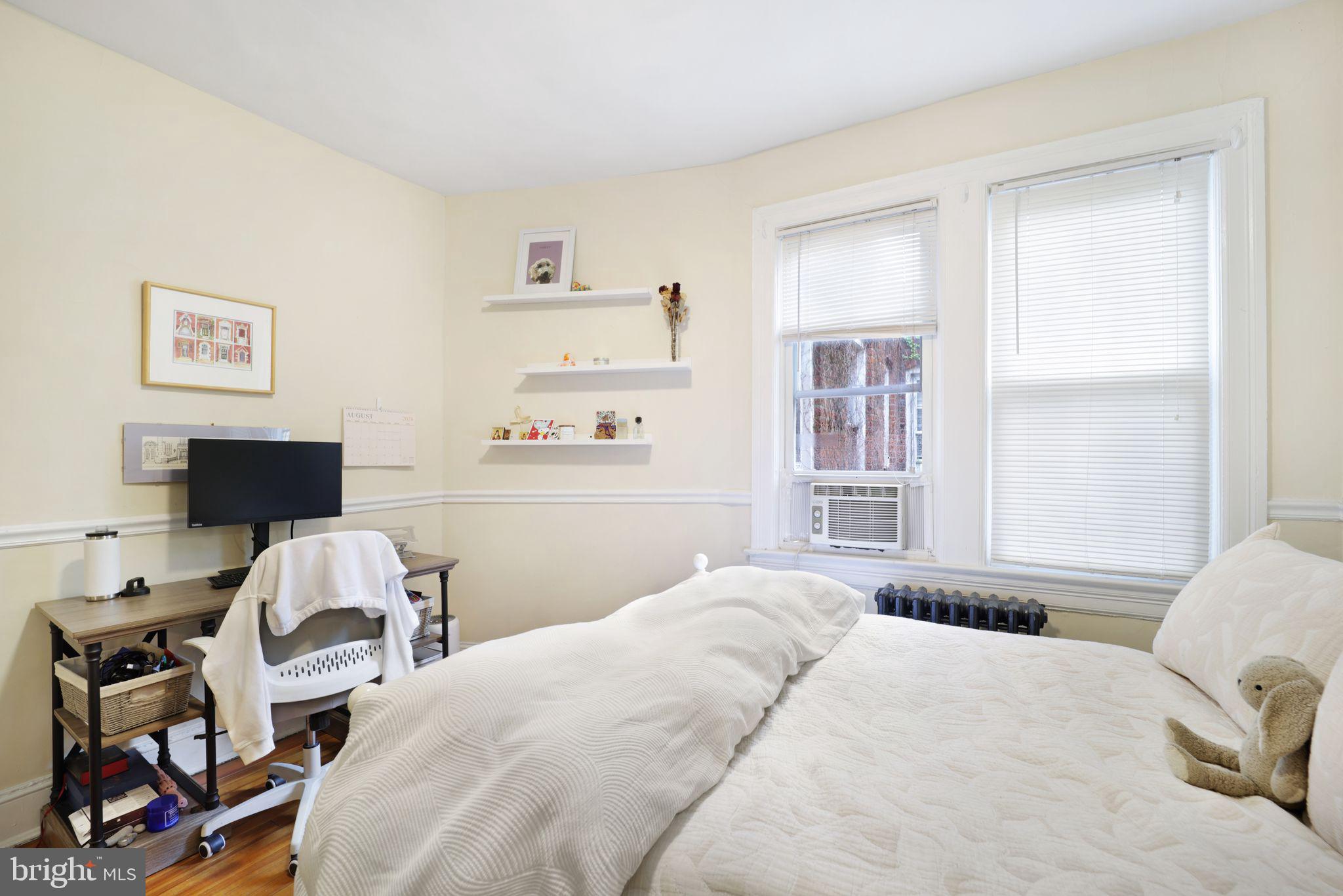 1426 12th Street Northwest, Unit 5 Washington, DC 20005 - Photo 15 of 21 a bedroom with a bed and a window