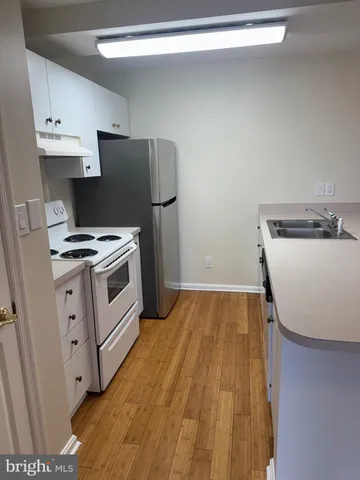a kitchen with a sink appliances and cabinets