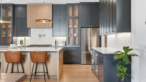 a kitchen with stainless steel appliances granite countertop a refrigerator and a stove