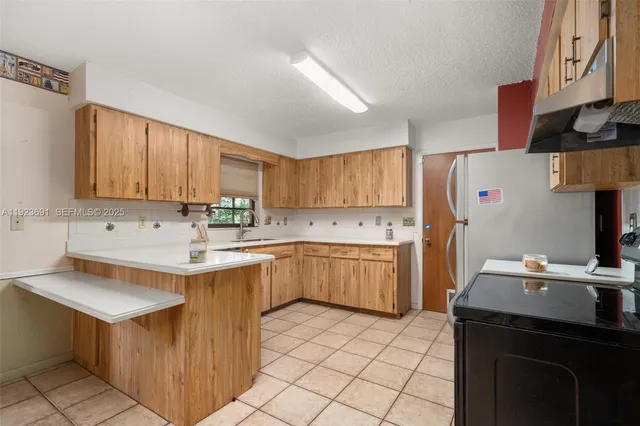 a kitchen with a sink cabinets and appliances