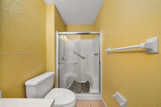 a bathroom with a toilet and a shower