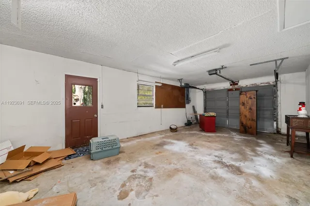 a view of a livingroom with workspace and a window