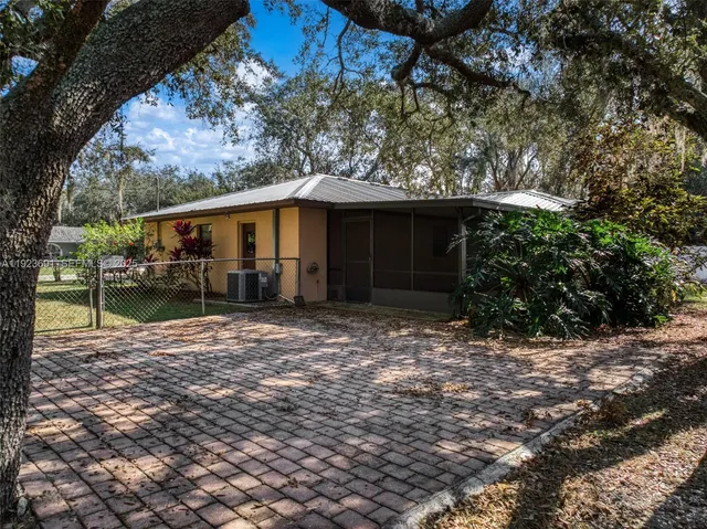a backyard of a house with yard and outdoor seating