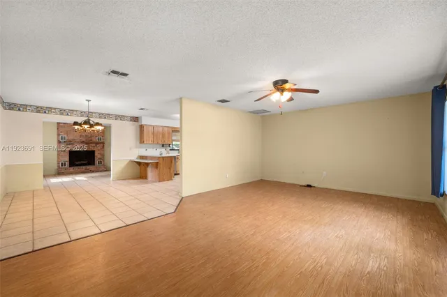 a view of a livingroom with a kitchen and a fireplace