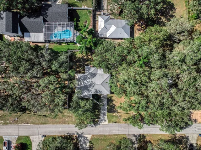 an aerial view of a house with a yard