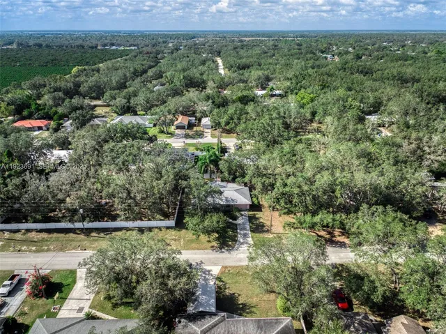 an aerial view of a houses with a yard