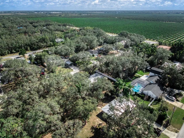 an aerial view of a houses with outdoor space and a lake view