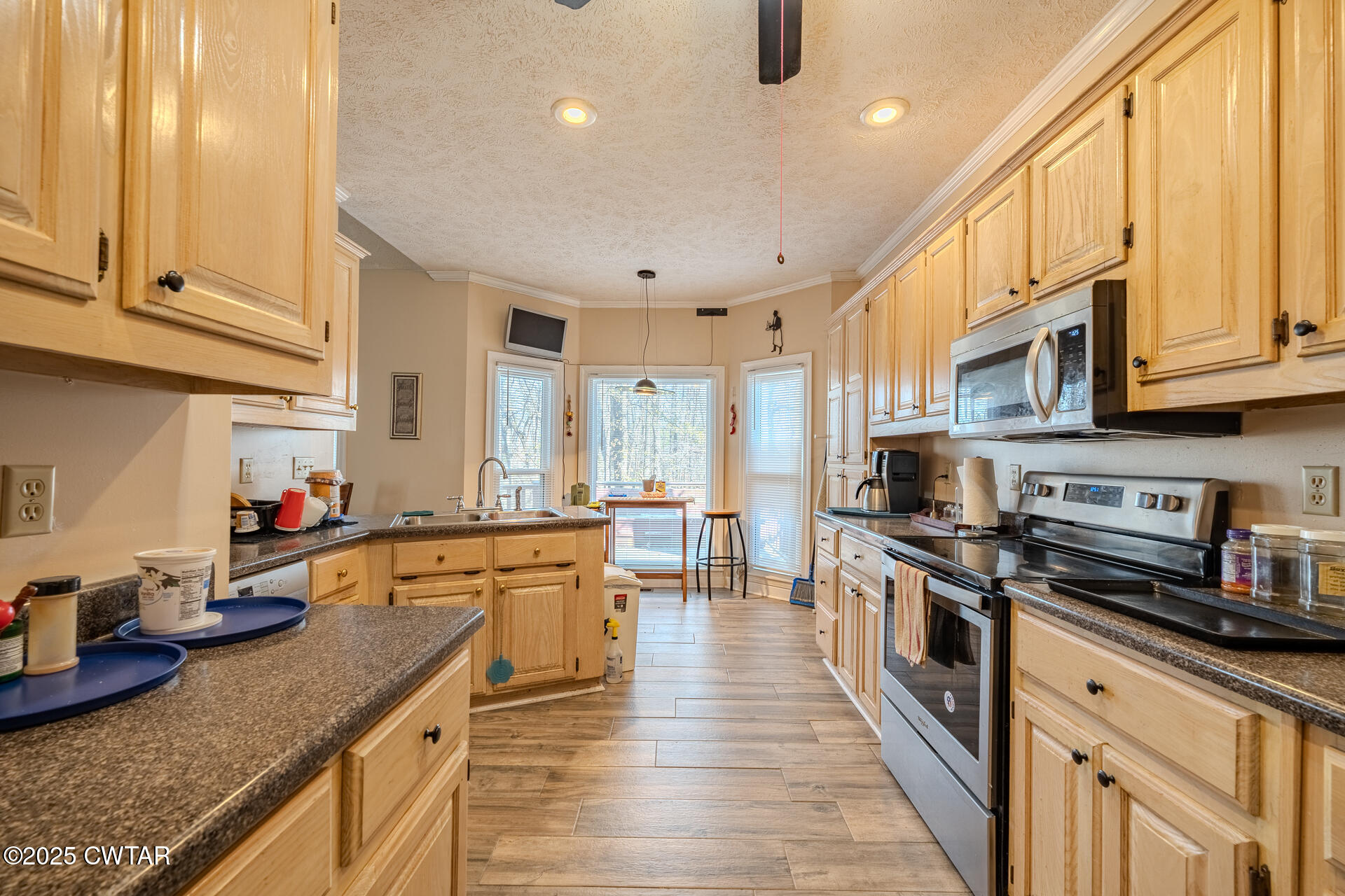 43 Paddock Place Jackson, TN 38305 - Photo 12 of 38 a kitchen with stainless steel appliances granite countertop wooden cabinets a sink dishwasher a stove and a refrigerator with wooden floor