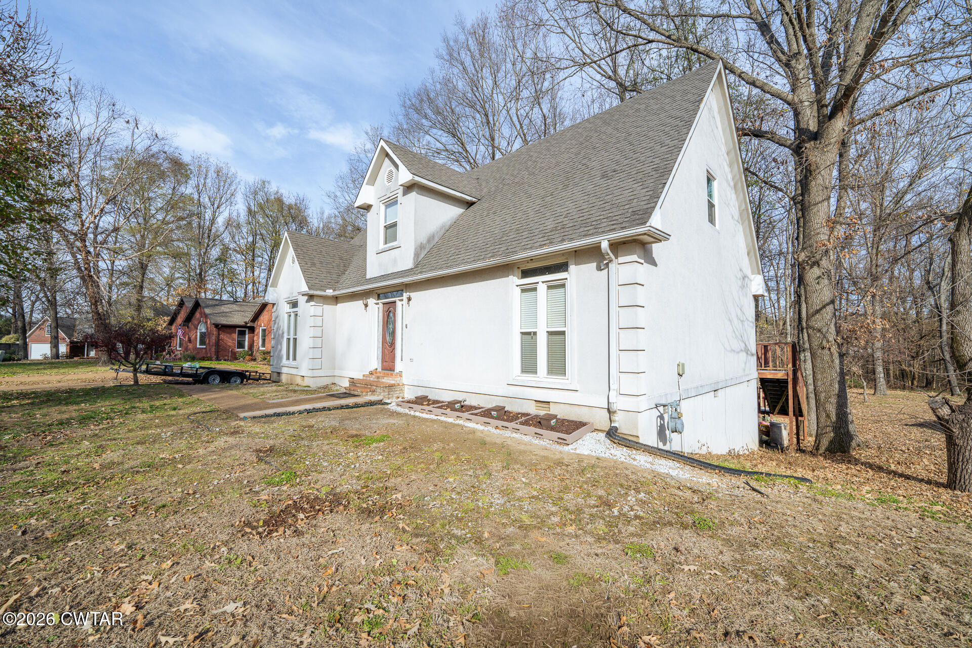 43 Paddock Place Jackson, TN 38305 - Photo 3 of 38 a view of a house with a yard covered in snow