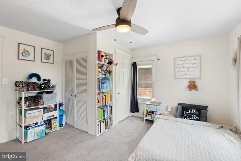 a bedroom with a bed dresser and a window