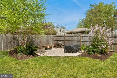 a view of backyard with swimming pool and outdoor seating