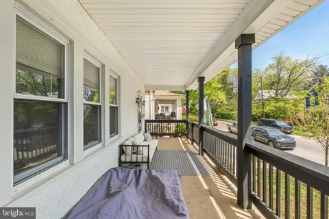 a view of a balcony with chairs and wooden floor