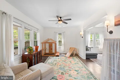 a living room with furniture fireplace and a large window