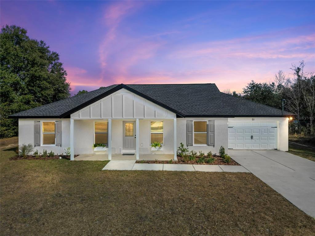 51 Aspen Road Ocala, FL 34480 - Photo 1 of 1 a front view of a house with garden