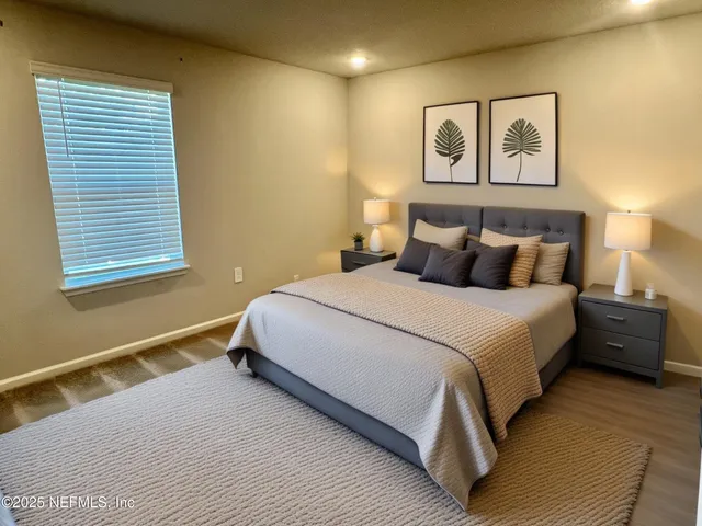 a bedroom with a bed and painting on the wall