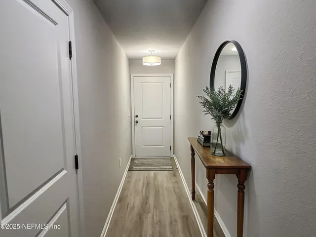 a kitchen with a sink a refrigerator and cabinets