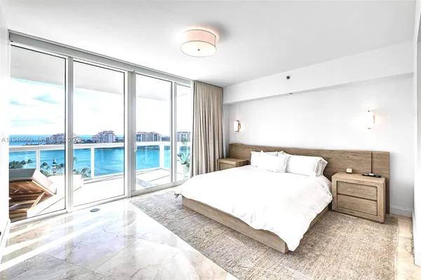 a bedroom with a large bed and a large window