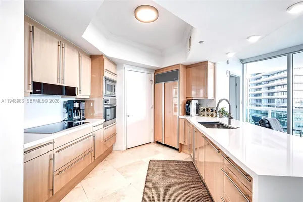 a kitchen with stainless steel appliances granite countertop a sink and cabinets