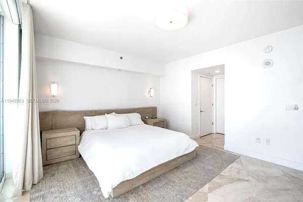 a bedroom with a bed and a night stand